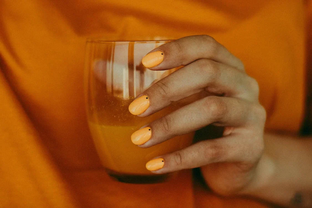 Crop woman drinking natural refreshing orange juice