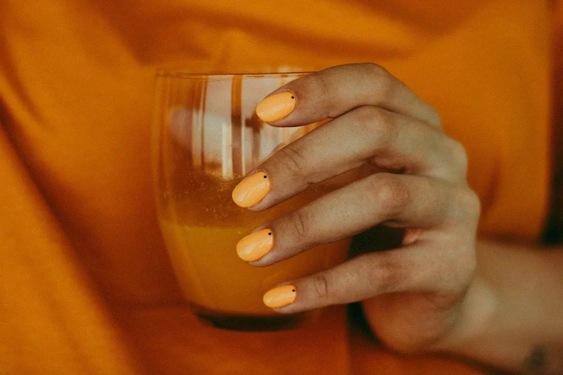 Crop woman drinking natural refreshing orange juice