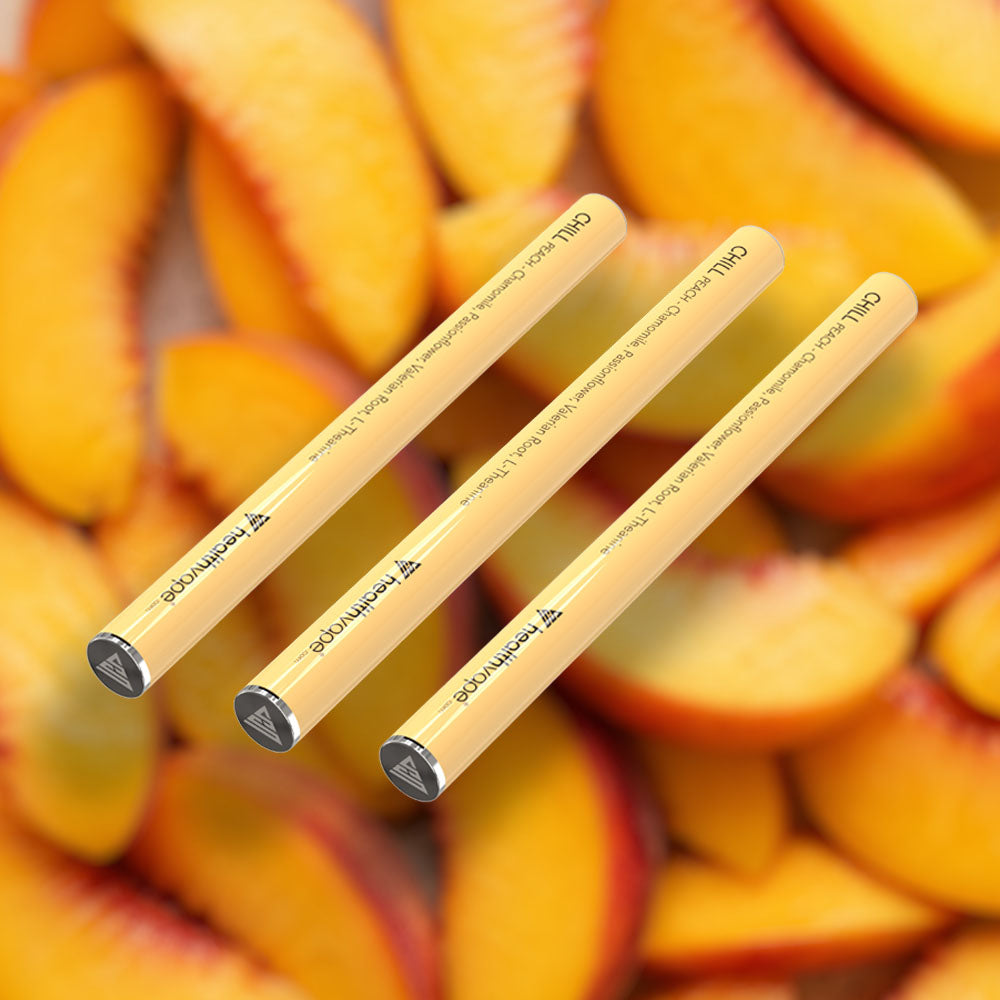 Three HealthVape CHILL Peach chamomile pens on peach fruit background