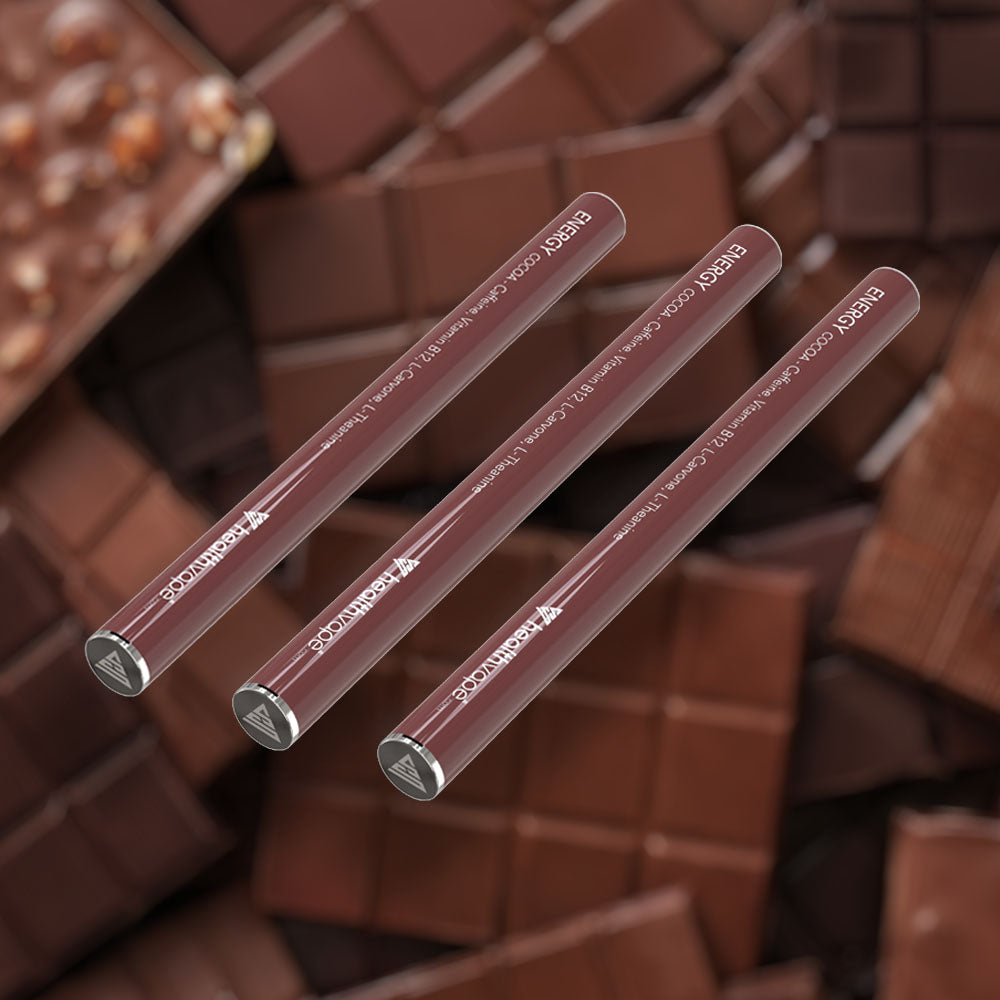 Three HealthVape ENERGY Cocoa caffeine pens on chocolate and cocoa background