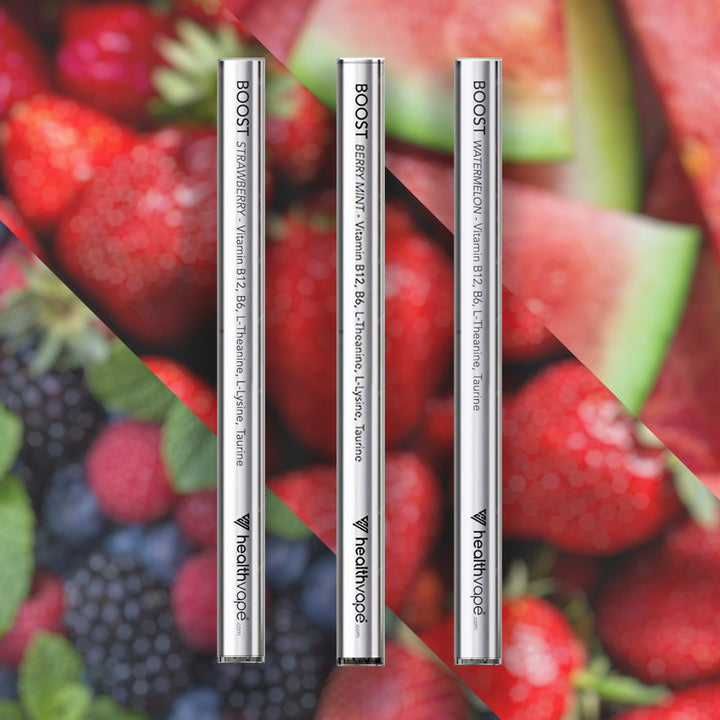 HealthVape BOOST B12 bundle: Strawberry, Berry Mint, and Watermelon pens on fruit background