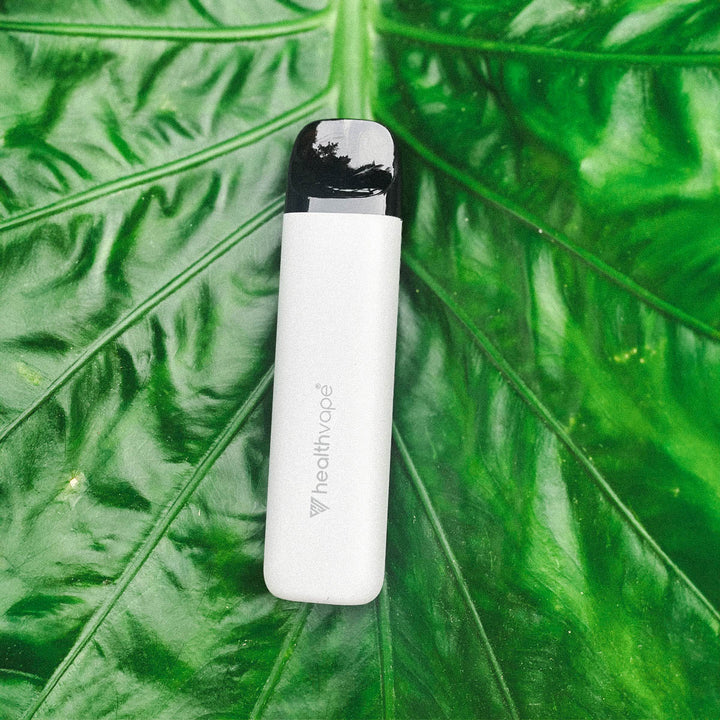 HealthVape rechargeable device standing next to pod box on a nightstand