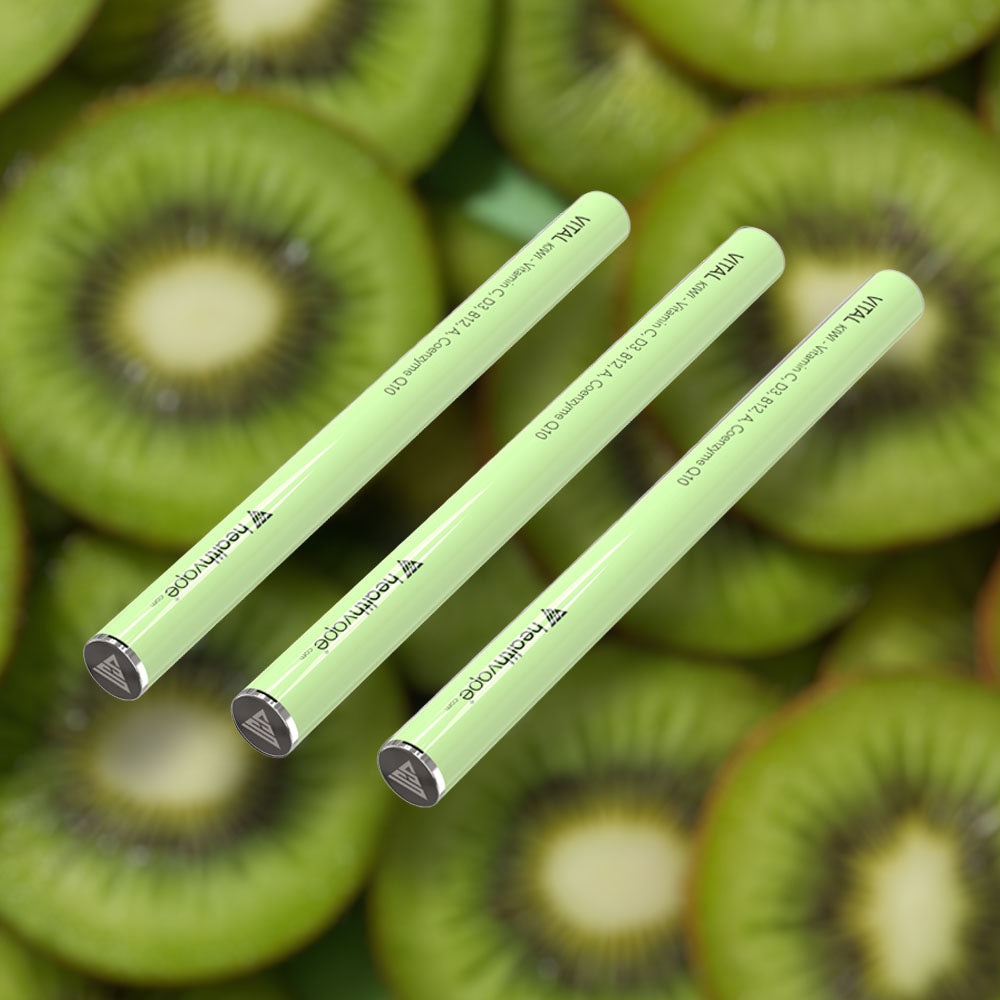 Three HealthVape VITAL Kiwi Vitamin C pens on kiwi fruit background