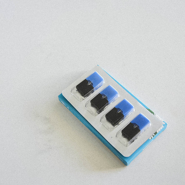 Pack of four blue and black HealthVape Restore Collagen Peppermint pods in blister tray