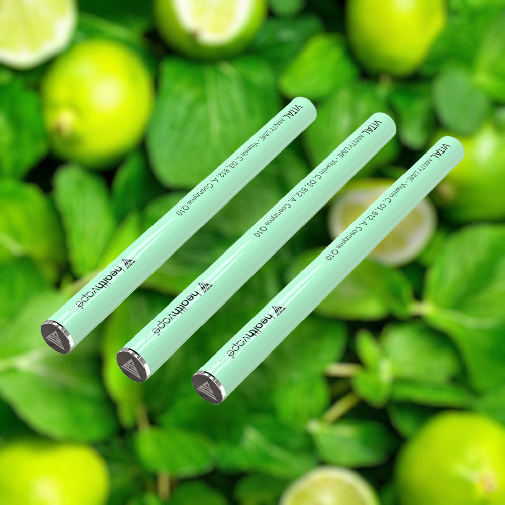 Three HealthVape VITAL Minty Lime Vitamin C pens on lime and mint background